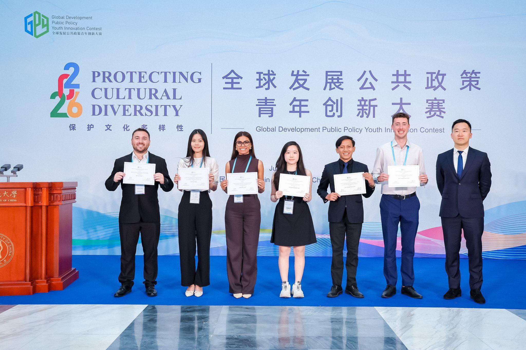 Award recipients pose with certificates on stage at the SDGs Youth Public Policy Innovation Challenge awards ceremony.