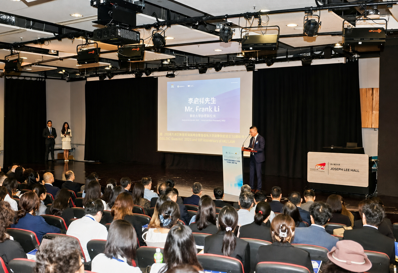 A speaker delivers a presentation on stage during the Forum.