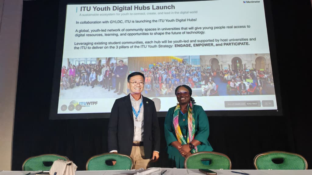 Speakers stand beneath the ITU Youth Digital Hubs launch presentation.