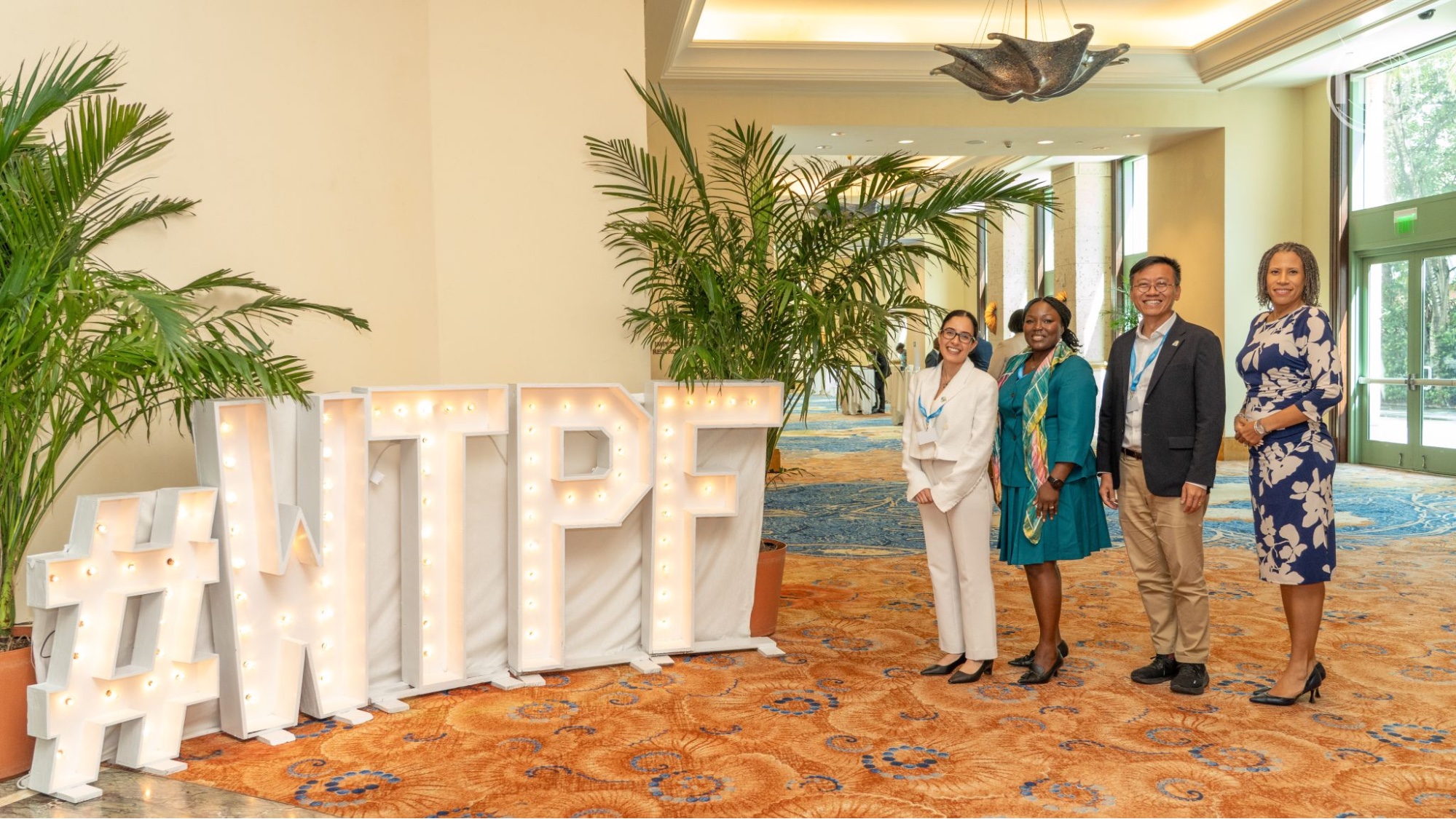 Delegates gather beside the ITU WTPF-26 display in Nassau, The Bahamas.